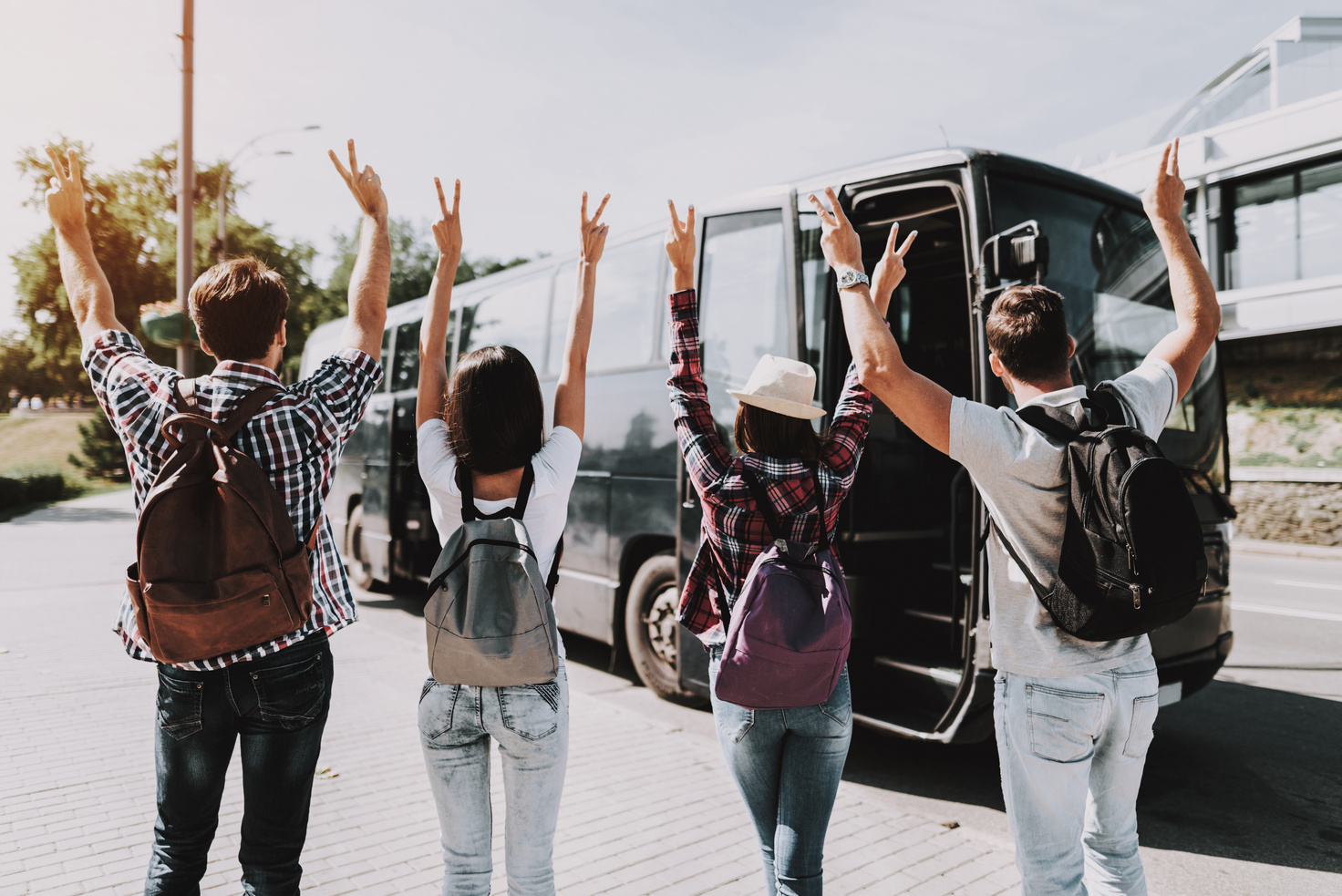 Young People having Fun in front of Tour Bus