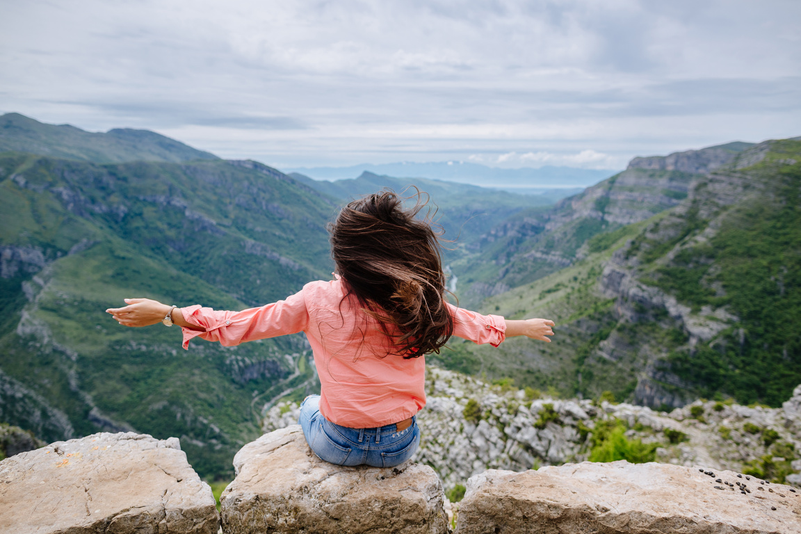 joyful woman travel mountains